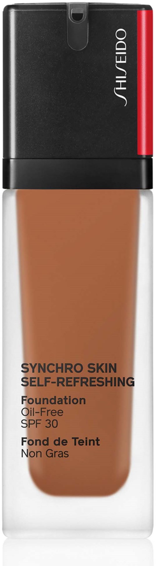 Eine Foundation-Flasche mit schwarzem Deckel, rotem Streifen und beige Flüssigkeit, beschriftet Shiseido Synchro Skin.