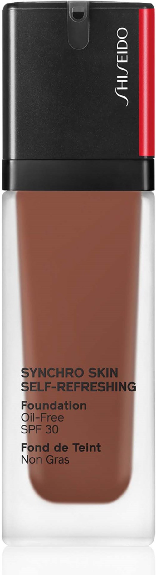 Eine Foundationsflasche mit schwarzem und rotem Deckel und beiger Flüssigkeit. Marke ist Shiseido, ölfrei mit SPF 30.
