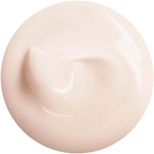 En rund, beige föremål med en liten formad knopp på ytan, liknande en klick grädde eller lotion.