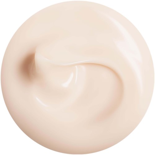 Kremaktig, glatt substans i en virvelform, lys beige farge, glanset overflate.