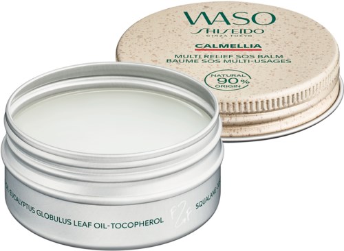 A white jar of balm with green text, with a round box lid on top, containing natural ingredients for skin relief.