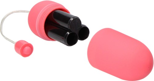 En rosa liten beholder med svarte flasker inni, og et matchende rosa lokk ved siden av.