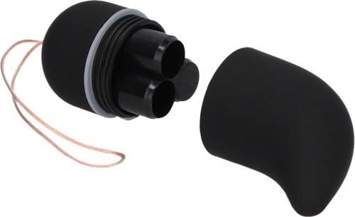 A black capsule-shaped container with a removable lid, holding three small black objects, possibly makeup or cosmetic items.