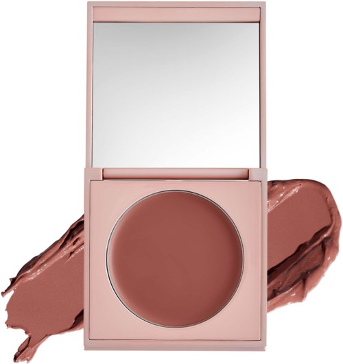 A pink makeup compact with a mirror and brown blush inside, with smudges of blush on the surface.