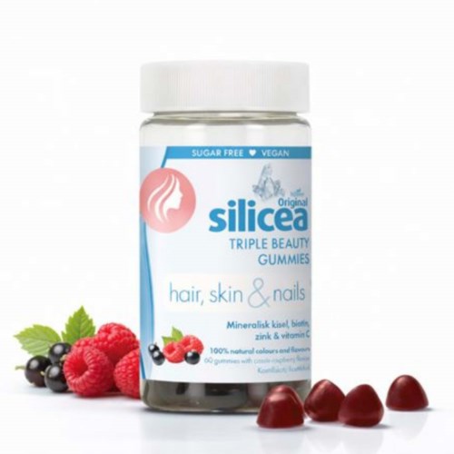 A jar of Silicea Triple Beauty Gummies for hair, skin, and nails, with fresh berries around it.
