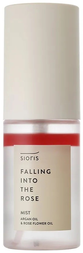 A small bottle with a white cap, pink liquid, and a label reading 'Falling Into The Rose' with mentions of argan oil.