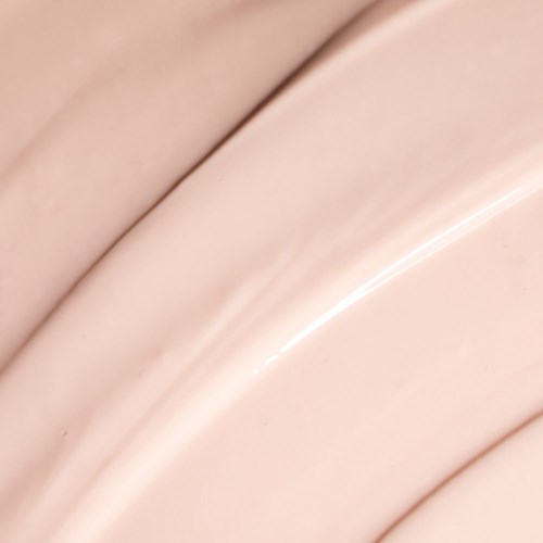 Närbild av slät, rosa, kurvad yta med glansiga ljuspunkter.