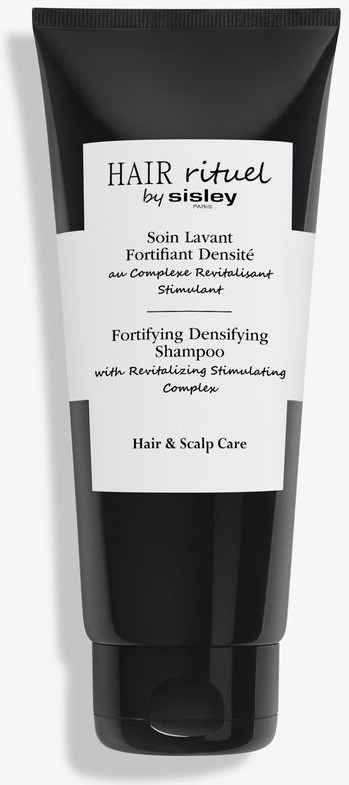 Mustavalkoinen shampoopäällä, jossa lukee "Hair rituel by Sisley" hiusten ja päänahan vahvistamiseen ja stimulaatioon.