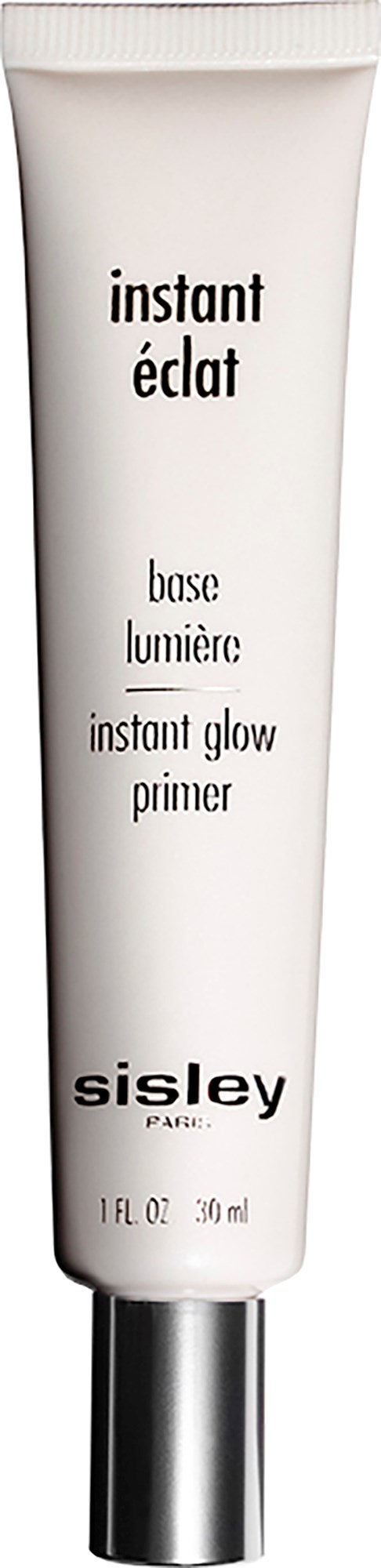 En vit tub för en lystergivande primer med svart text från Sisley Paris, märkt 'instant éclair' och 'instant glow primer.'