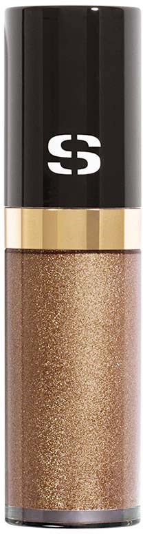 A glittery brown liquid in a clear tube with a black and gold cap.