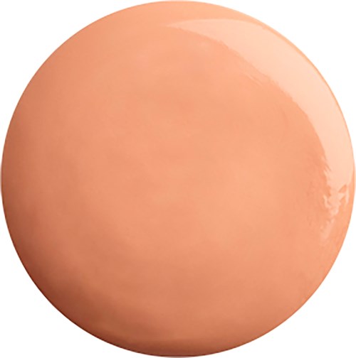 Dette er et nært bilde av et glatt, rundt, ferskenfarget egg med skinnende overflate.