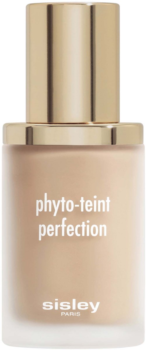A beige bottle with a gold cap, labeled 'phyto-teint perfection' by Sisley Paris, likely a skincare or makeup product.