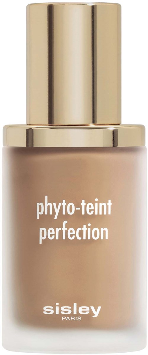 A bottle of foundation with a gold cap and beige liquid inside, labeled 'phyto-teint perfection' by Sisley Paris.