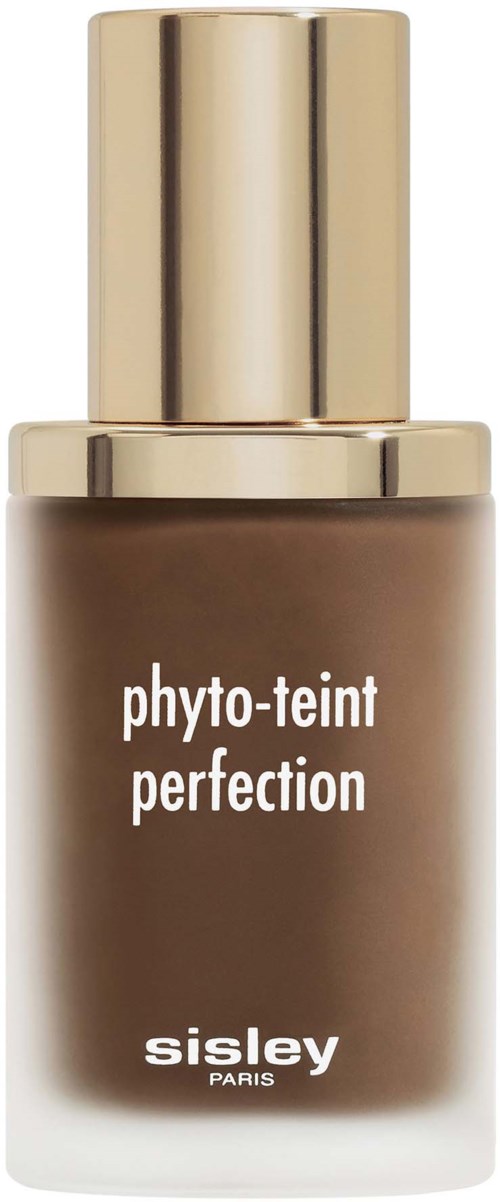 A brown bottle of Sisley face foundation with a shiny gold cap. The label has white text saying 'phyto-teint perfection'.