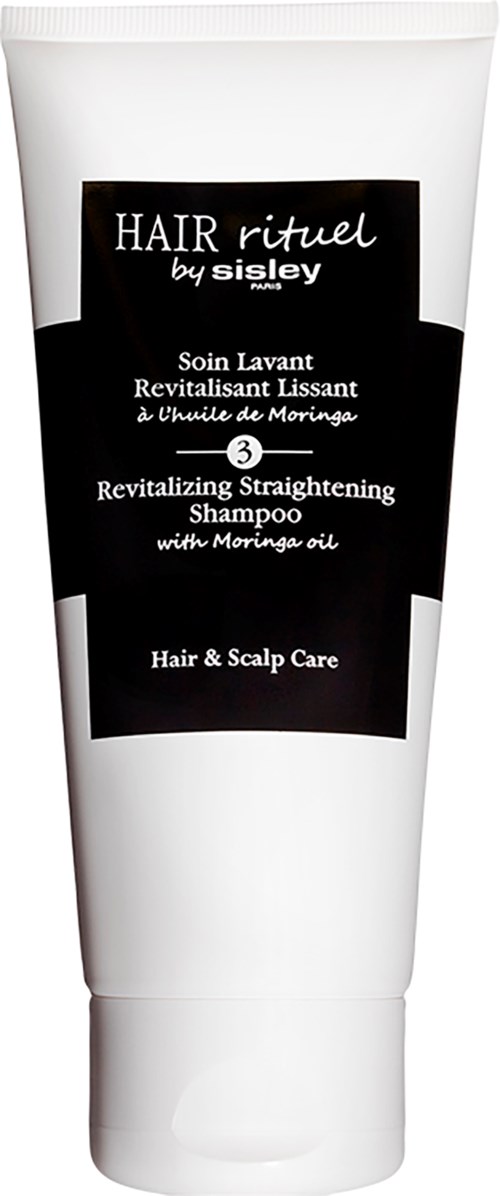 Valkoinen shampooputeli, jossa lukee 'Hair Rituel by Sisley' mustalla ja valkoisella tekstillä ja mustalla etikettillä.