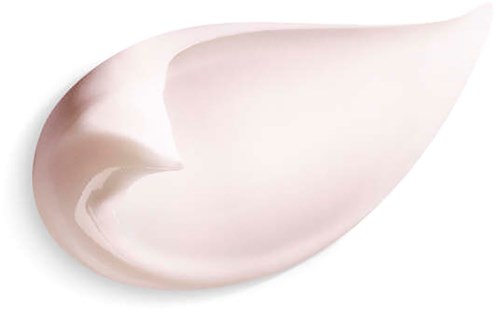 En stor klatt med hvit krem eller lotion formet som en tåre på en svart bakgrunn.