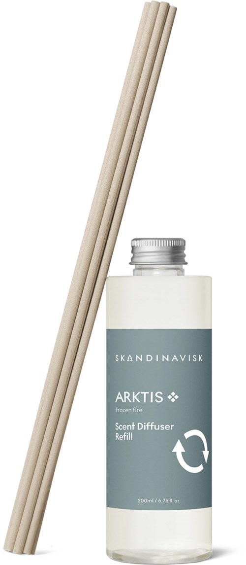 Red reed sticks and a bottle of scent diffuser refill labeled 'Skandinavisk Arctic.'