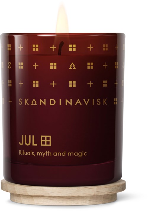 Et rødt lys med nordiske symboler og tekst, på et rundt trebasis.