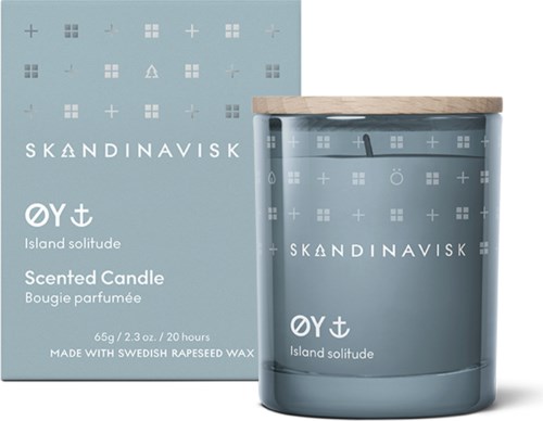 A scented candle and its box feature a light blue color with Nordic symbols and the words 'Skandinavisk' and 'Island solitude'.