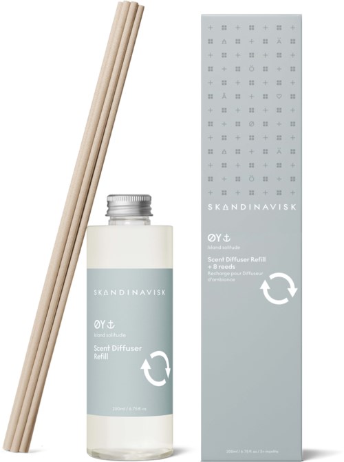 A scent diffuser refill bottle with wooden sticks and gray packaging box from Skandinavisk.