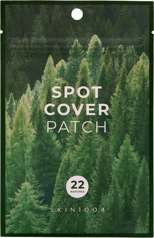 Grønn pose med skogstre, merket 'Spot Cover Patch,' for hud, med 22 plaster og koden 'SKIN1004.'
