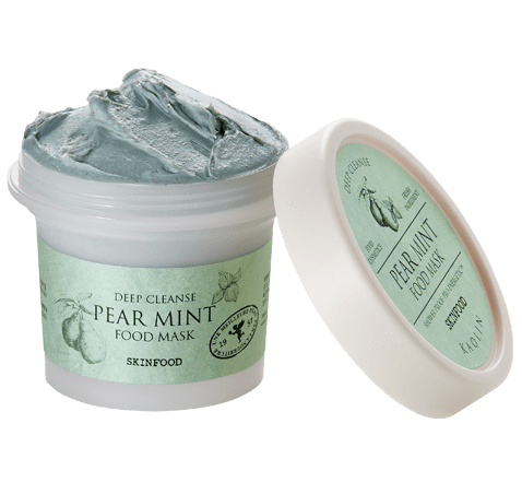 En boks med pear mint matmaske med grågrønn pasta inni og et lokk ved siden av.