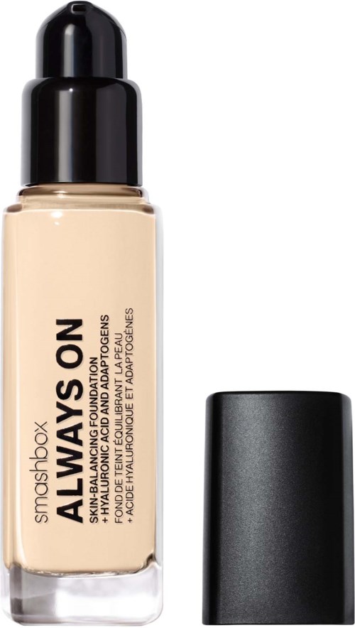 A foundation bottle with a black cap, labeled 'Always On' by Smashbox, contains beige liquid makeup.