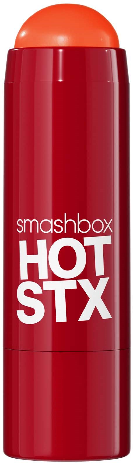 Punainen sylinterimäinen purkki, jossa on oranssi pyöristetty kärki, merkintä 'smashbox HOT STX'.