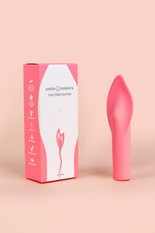 En rosa handhållen enhet som liknar en blomma bredvid en rosa låda med vit och rosa design, varumärke och information.