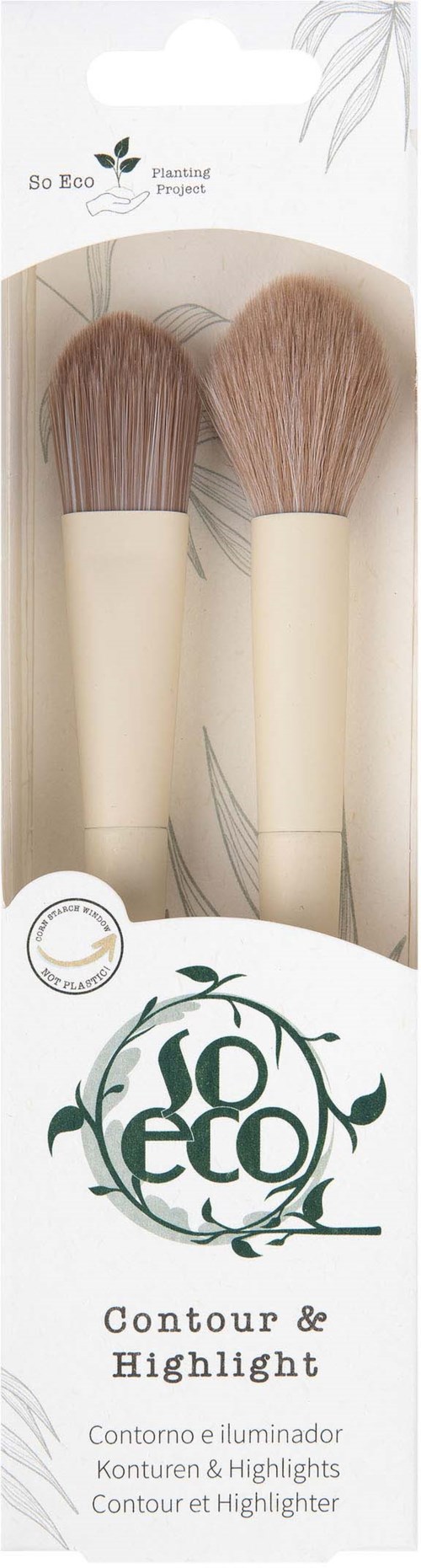 Two makeup brushes with light brown bristles in a white and green packaging. Logo and text describe contour and highlight tools.