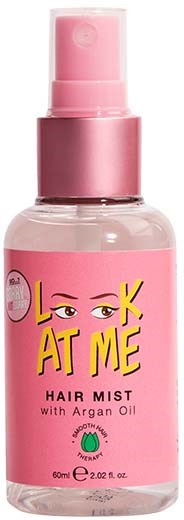 A pink spray bottle labeled "Look at Me" hair mist with argan oil, designed for hair care.