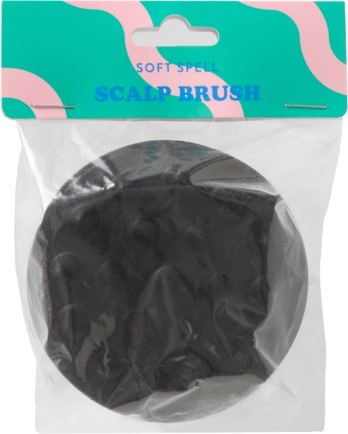 A soft spell scalp brush in black inside clear plastic packaging with a colorful top label.