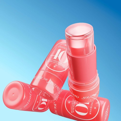 Pink lipstick tubes are arranged in a casual, overlapping manner on a blue background.