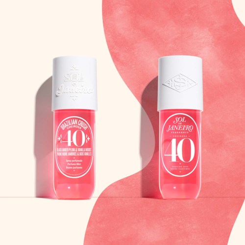 Two bottles with pink liquid, label shows celebrating 40 years, and white caps, placed on white and pink backgrounds.