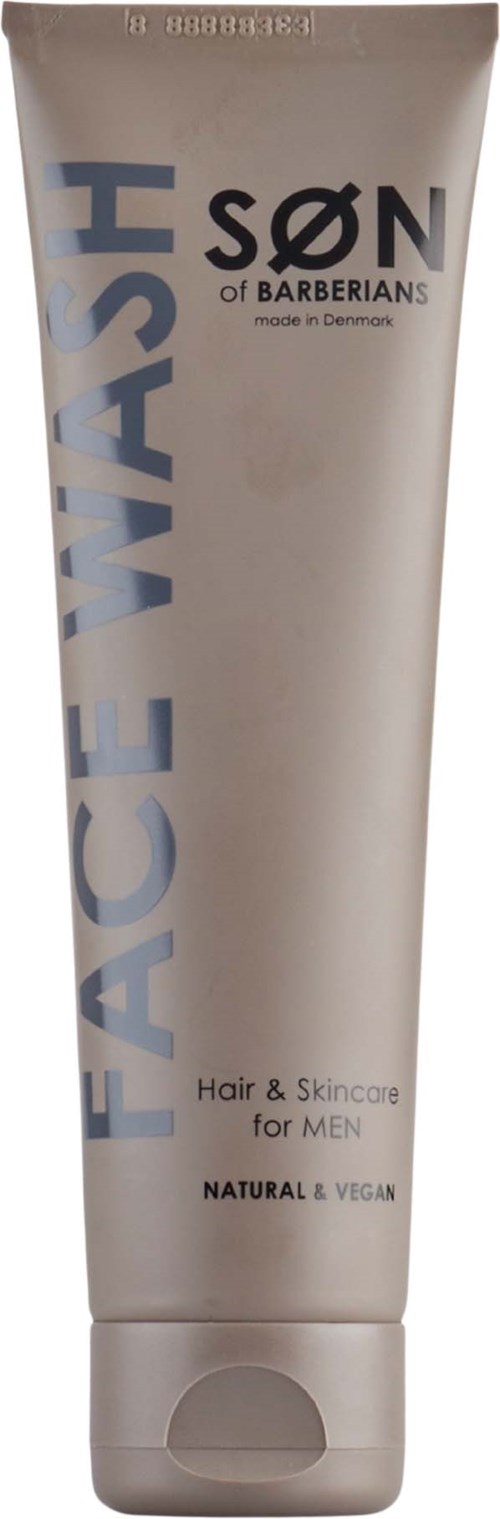 Een witte tube met 'FACE WASH' van SØN of BARBERIANS, gemaakt in Denemarken, voor huid- en haarverzorging voor mannen, natuurlijk en veganistisch.