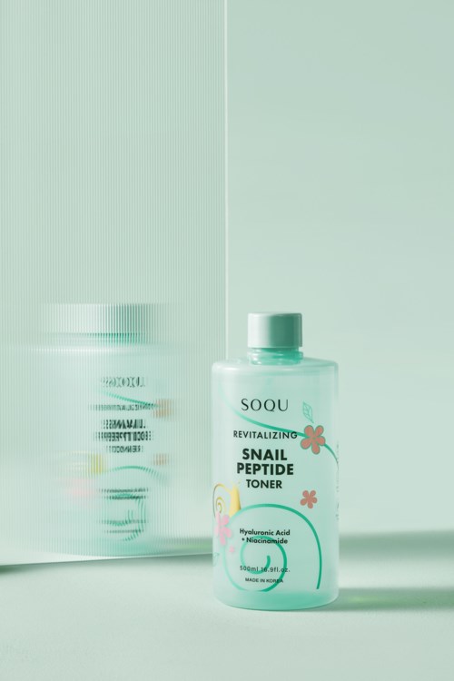 A bottle of skincare toner labeled 'Snail Peptide' with hydrating ingredients, placed on a light background.