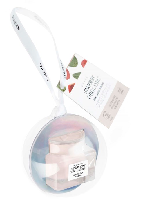 A skincare product in a jar with a clear lid, a white spatula, and a hanging tag. The label says 'Star Skin Organic'.