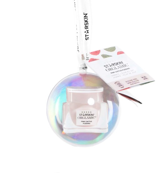 A small jar of skincare cream inside a holographic ball with a tag attached. The product is called 'Pink Cactus Pudding.'