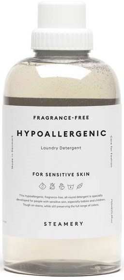 A clear bottle with a white cap, labeled as fragrance-free, hypoallergenic laundry detergent for sensitive skin, with steamery scent.