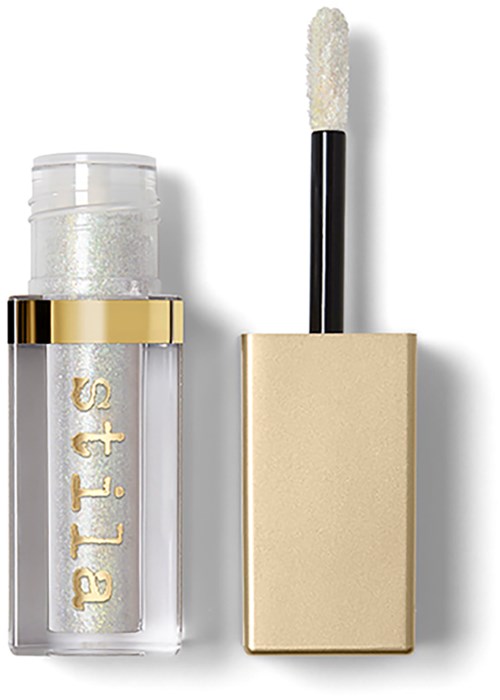 A clear bottle with white glitter inside and a black and gold cap, with a white sponge applicator on top.