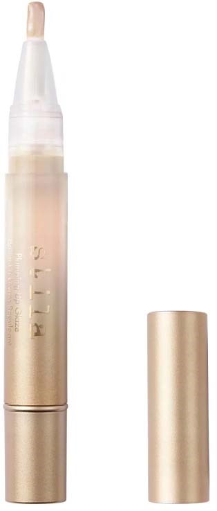 Ett penliknande sminkprodukt med guldlock och genomskilnigt kropp som visar en lätt makeup-stav.