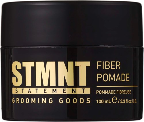 En sort beholder med fed gul og hvid tekst, mærket som fiber pomade til grooming varer, 100 ml.