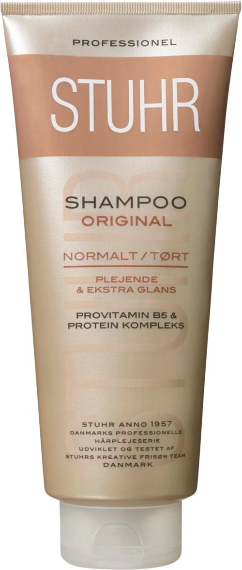 Trzymana w ręku tubka szamponu w kolorze beżowym i białym z brązowymi akcentami, oznaczona jako 'STUHR SHAMPOO ORIGINAL'.
