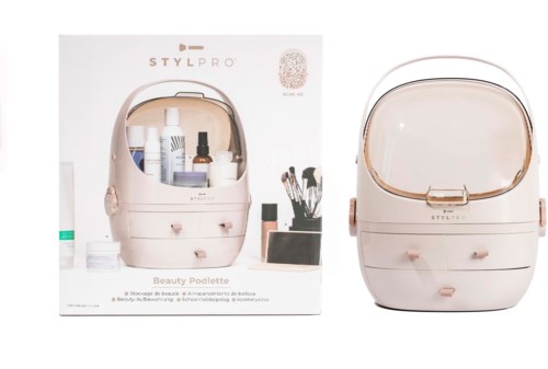 A beauty storage case with a mirror, bottles, brushes, and a box in the background. It looks organized and stylish.