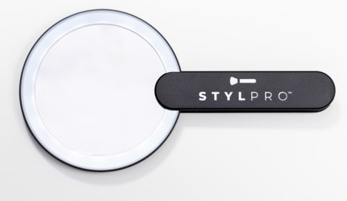 En sort spatula med mærket 'STYL PRO' og et rundt spejl eller lys.