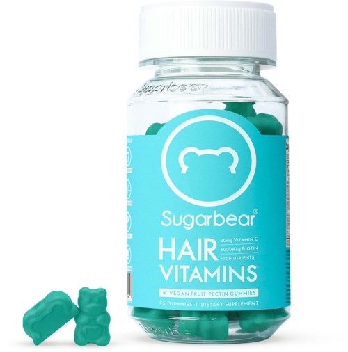 Flaska med hårvitaminer med gummibjörnar och några gummies utanför. Etiketten visar att den innehåller vitaminer och näringsämnen.