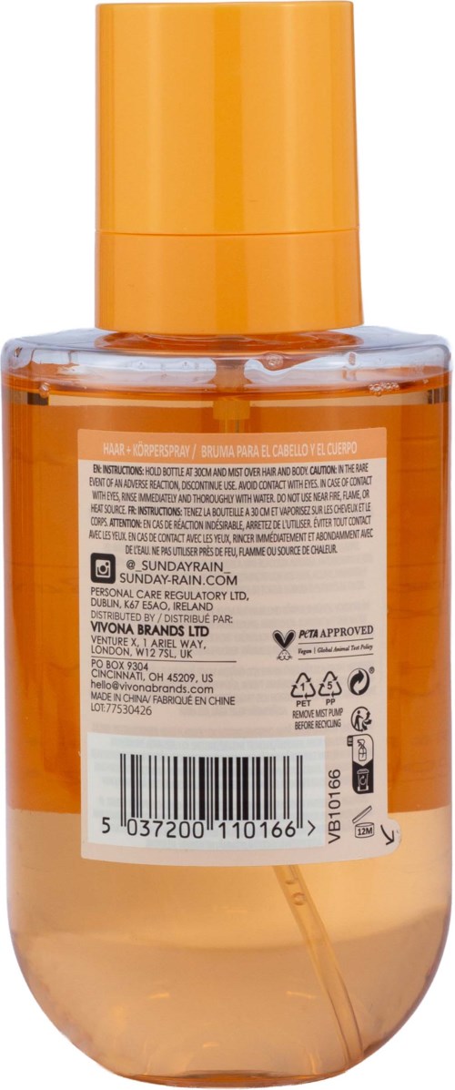Back of a clear orange skincare bottle with a label showing ingredients, barcode, and product information.