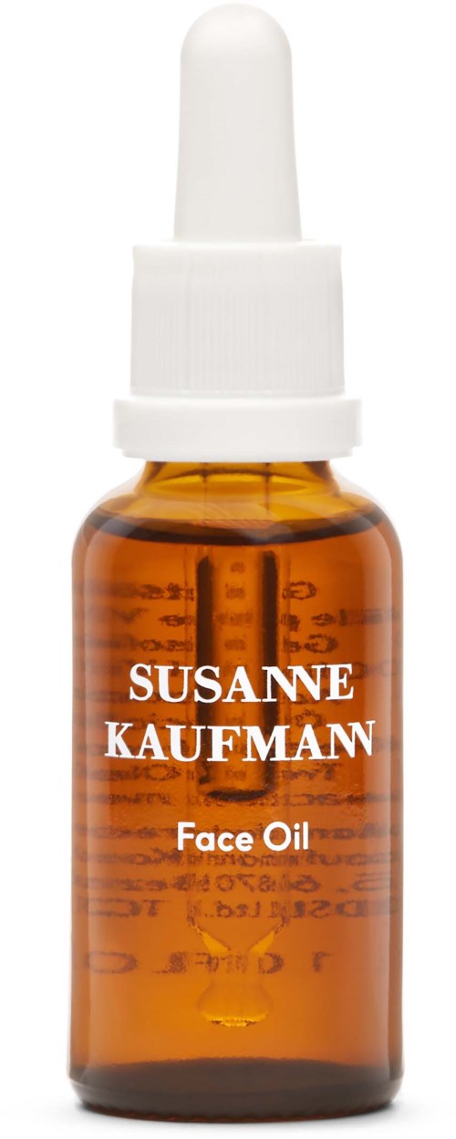 Pieni hunajakuvioinen lasipullo, jossa lukee 'SUSANNE KAUFMAN Face Oil' ja kattopullosuukko.