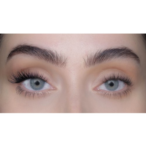 Close-up of a woman's eyes with makeup, one eye open wider with long eyelashes, the other partly closed.