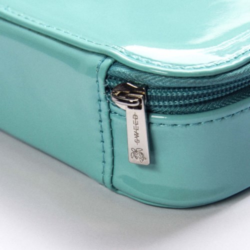 A close-up of a light blue bag with a zipper and stitched seams.